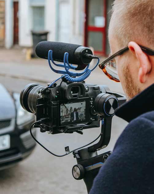 PASS Media team capturing a video of a man walking down the street for a digital marketing campaign